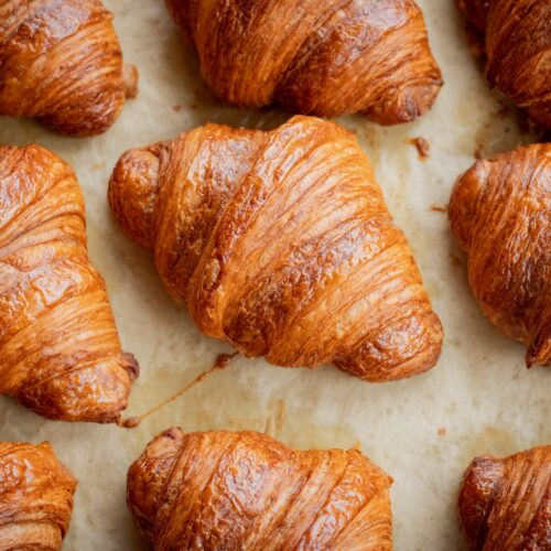 a bunch of croissants that are on a table